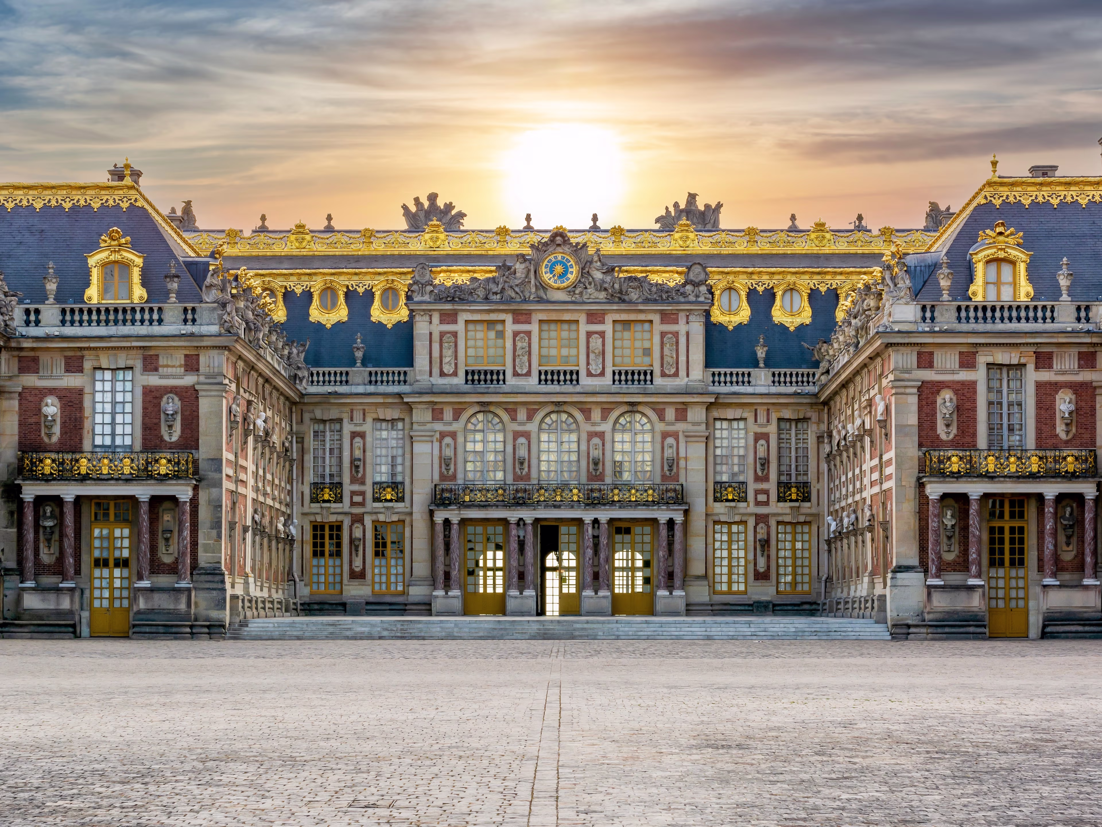 Palace of Versailles facade with the Royal Gate and golden railings